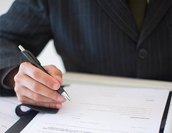 Close-up of a man writing with a pen
